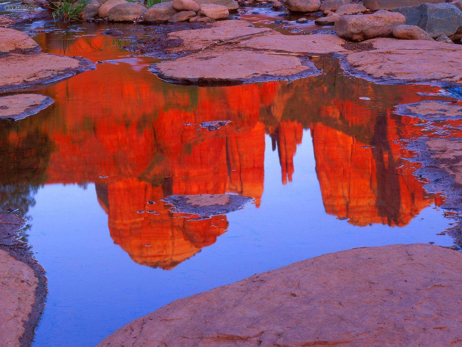 Red Rock Formations Water Reflection Background