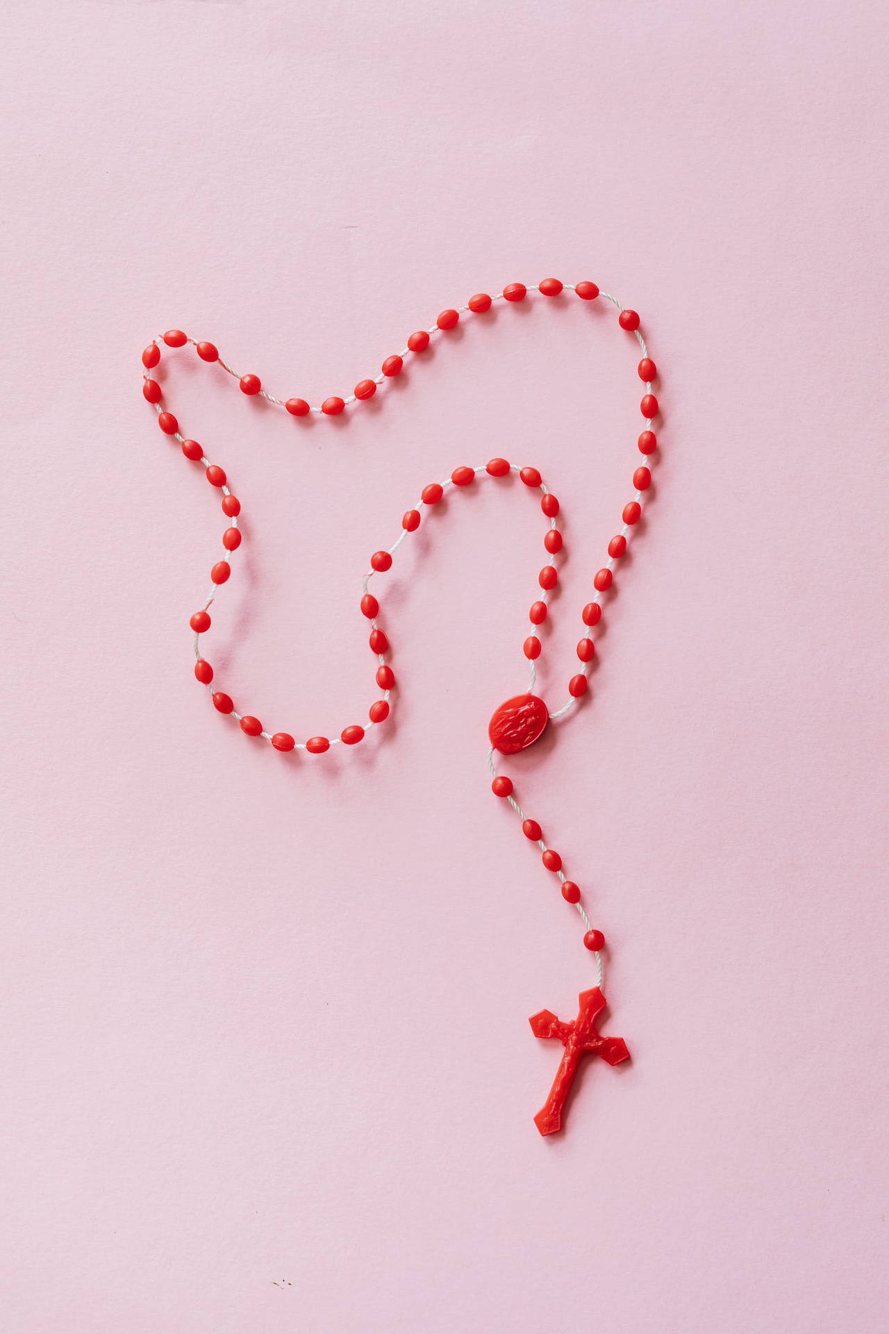 Red Rosary With Jesus On Cross Background