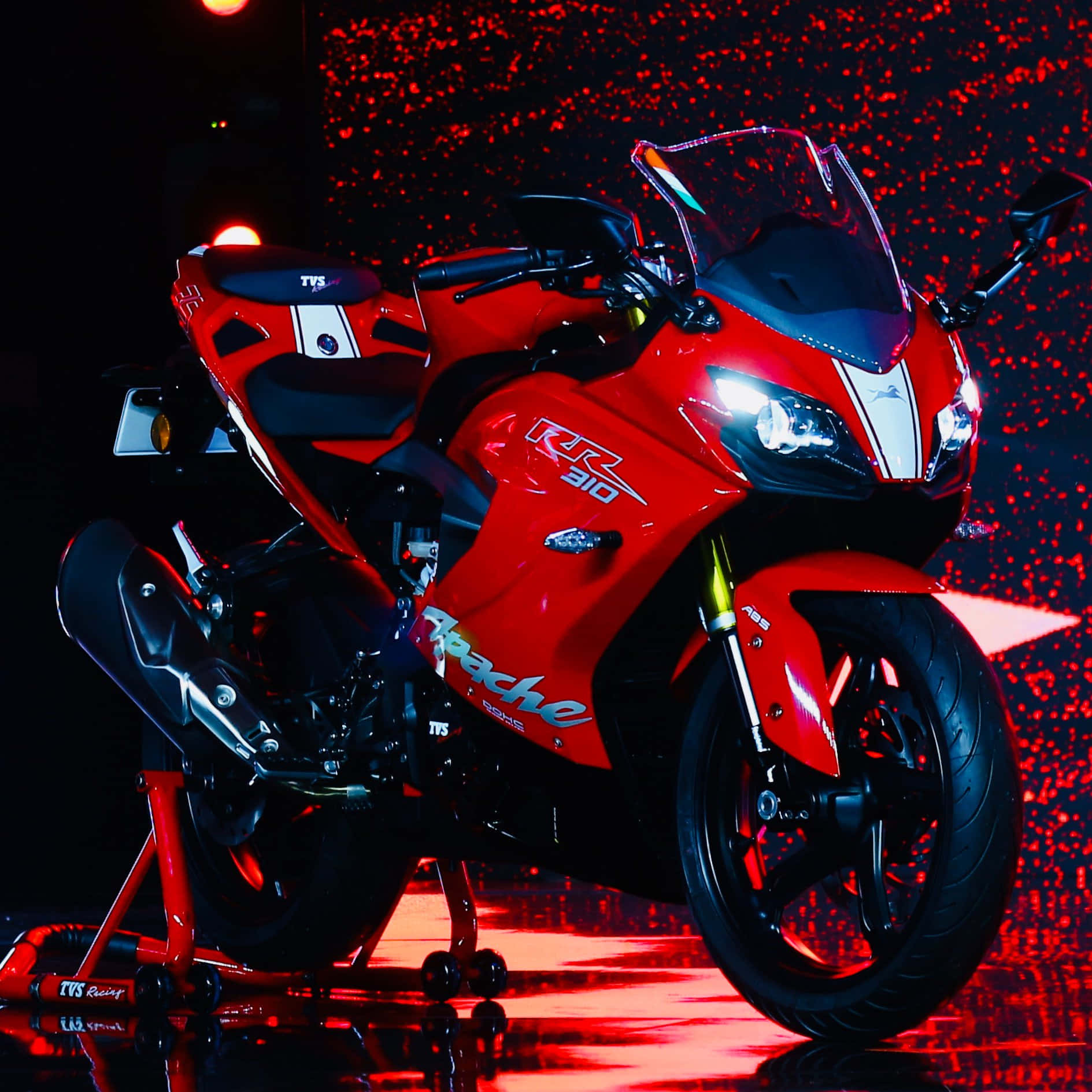 Red Sports Bike Under Spotlight Background