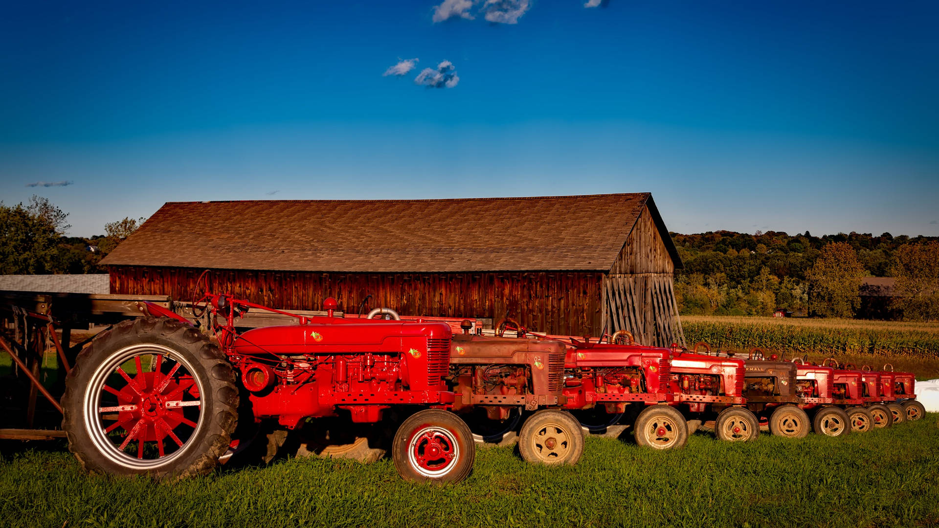 Red Tractor Parked On The Field Background