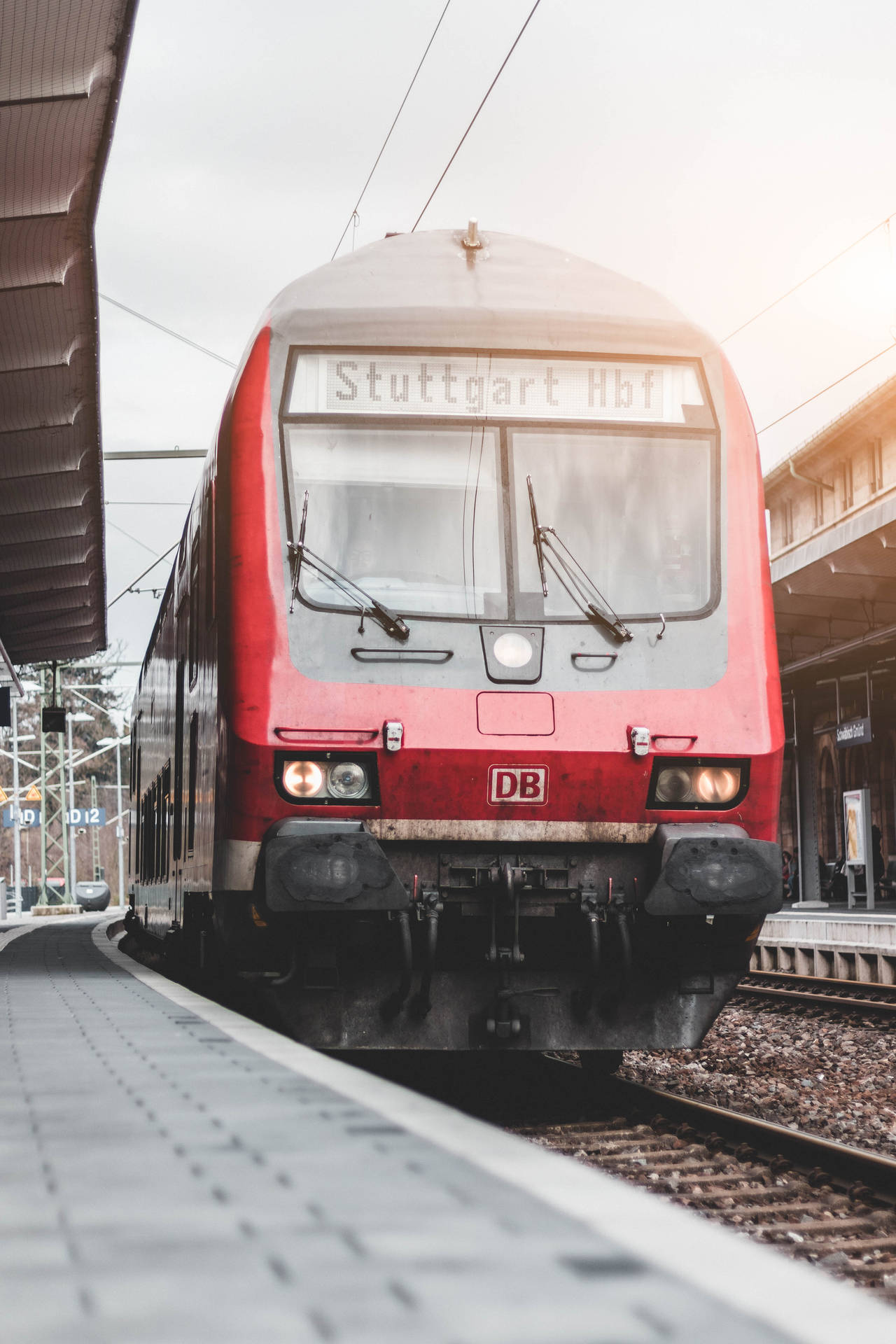 Red Train Arriving At The Stuttgart Hbf Station Background