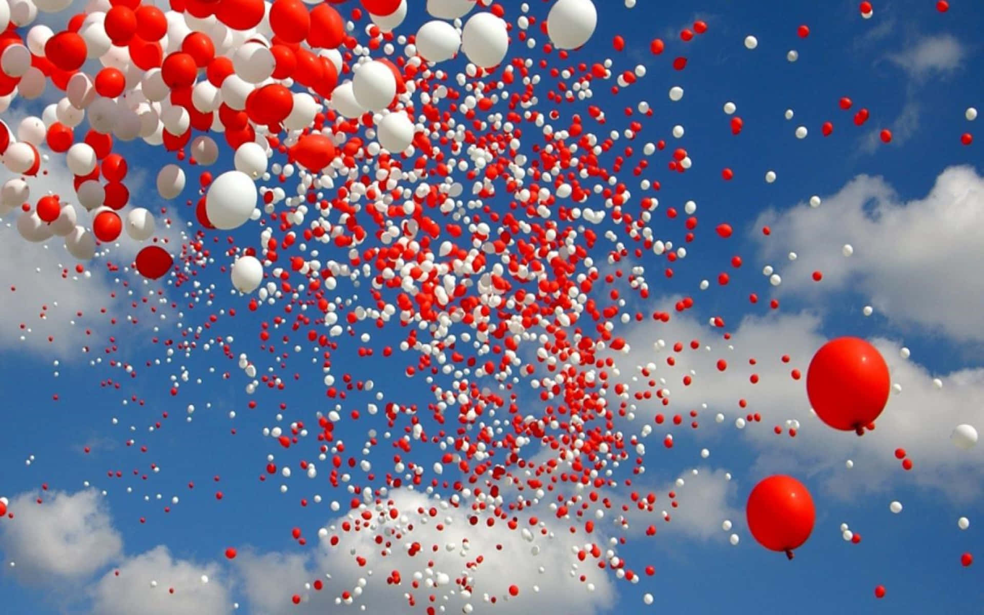 Redand White Balloons Against Blue Sky Background