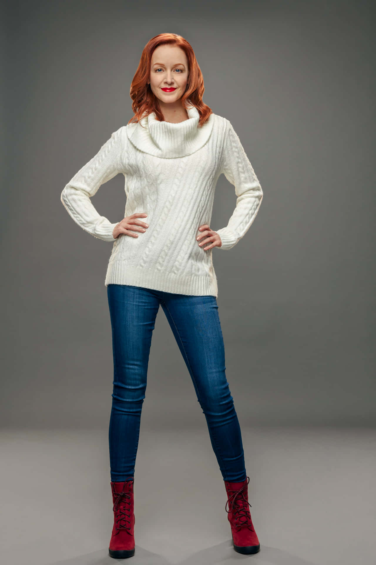 Redhead Womanin White Sweaterand Blue Jeans Background