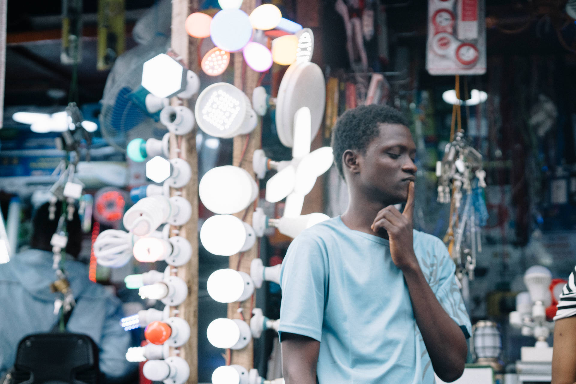 Reflective Man Contemplating Amidst The Lights In Sierra Leone