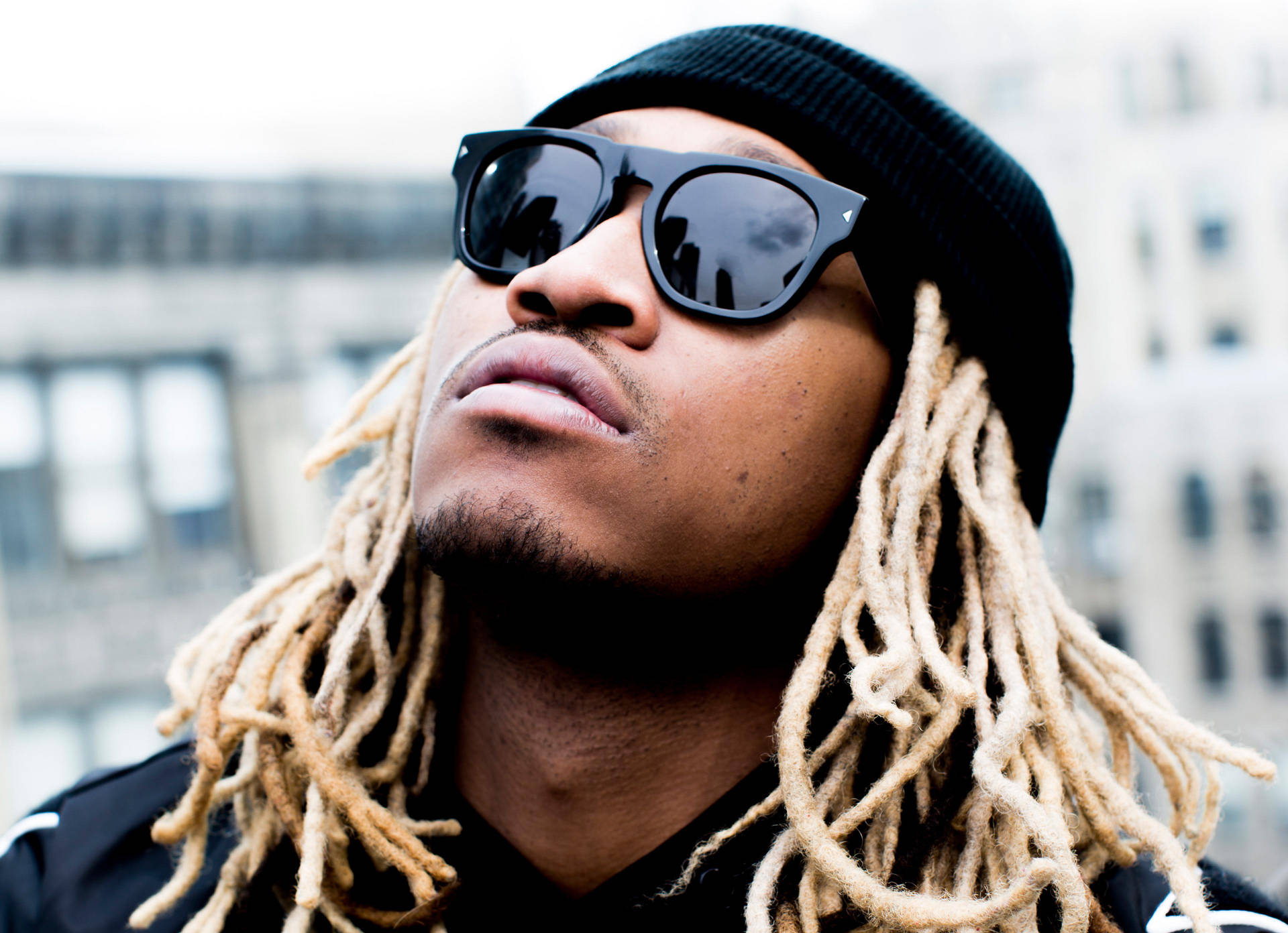 Reflective Man With Dreadlocks Gazing Towards The Sky Background