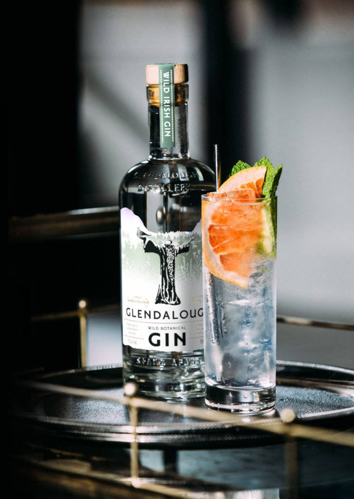 Refreshing Glendalough Wild Gin Tonic Cocktail Against A Rustic Backdrop Background