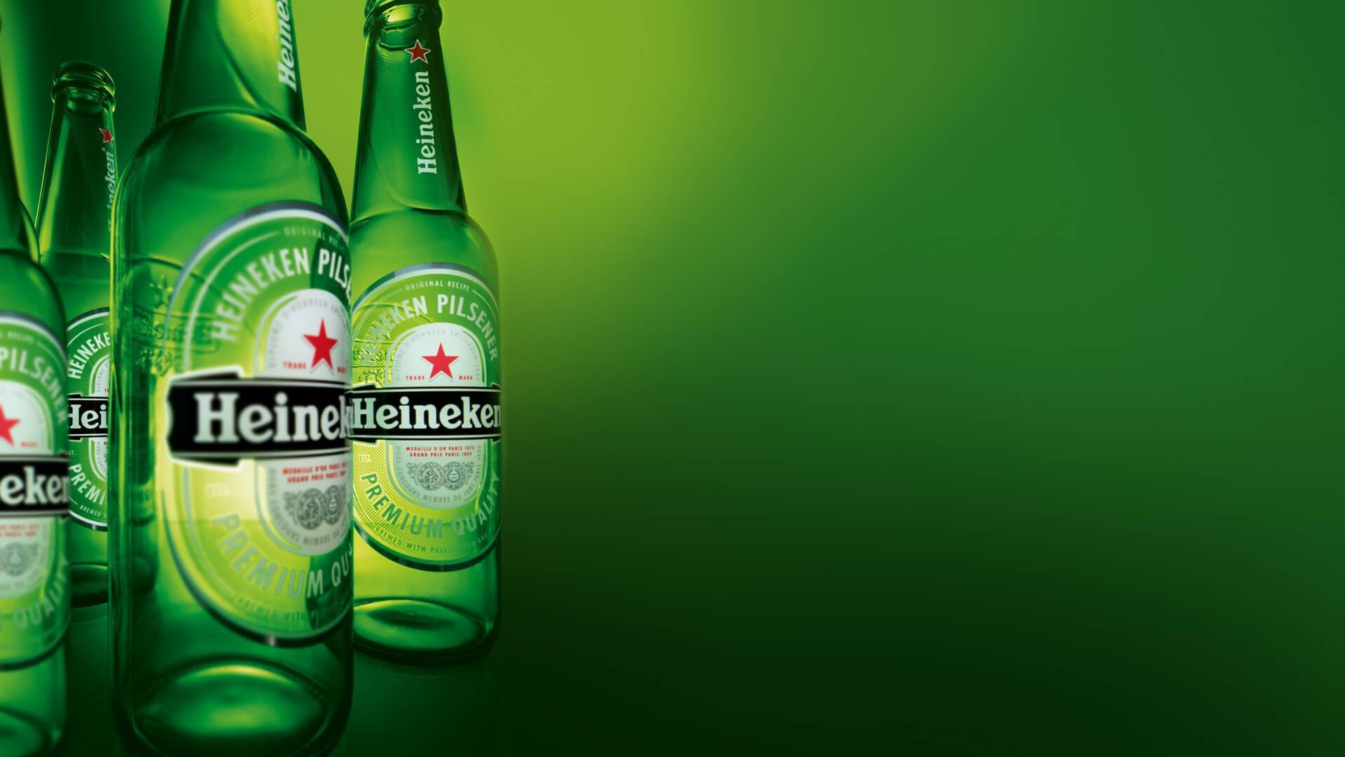 Refreshing Heineken Beer Bottles Lined Up Background