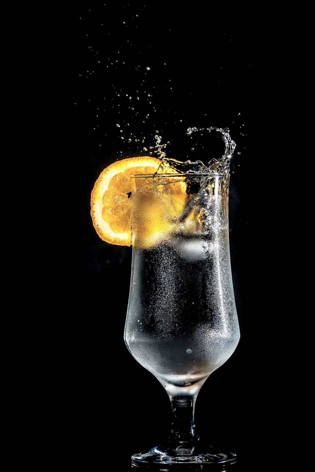 Refreshing Lemon Water On Black Background Background