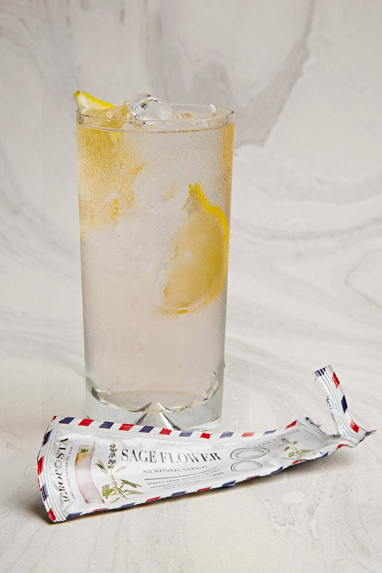 Refreshing Lemonade Cordial In Glass Background