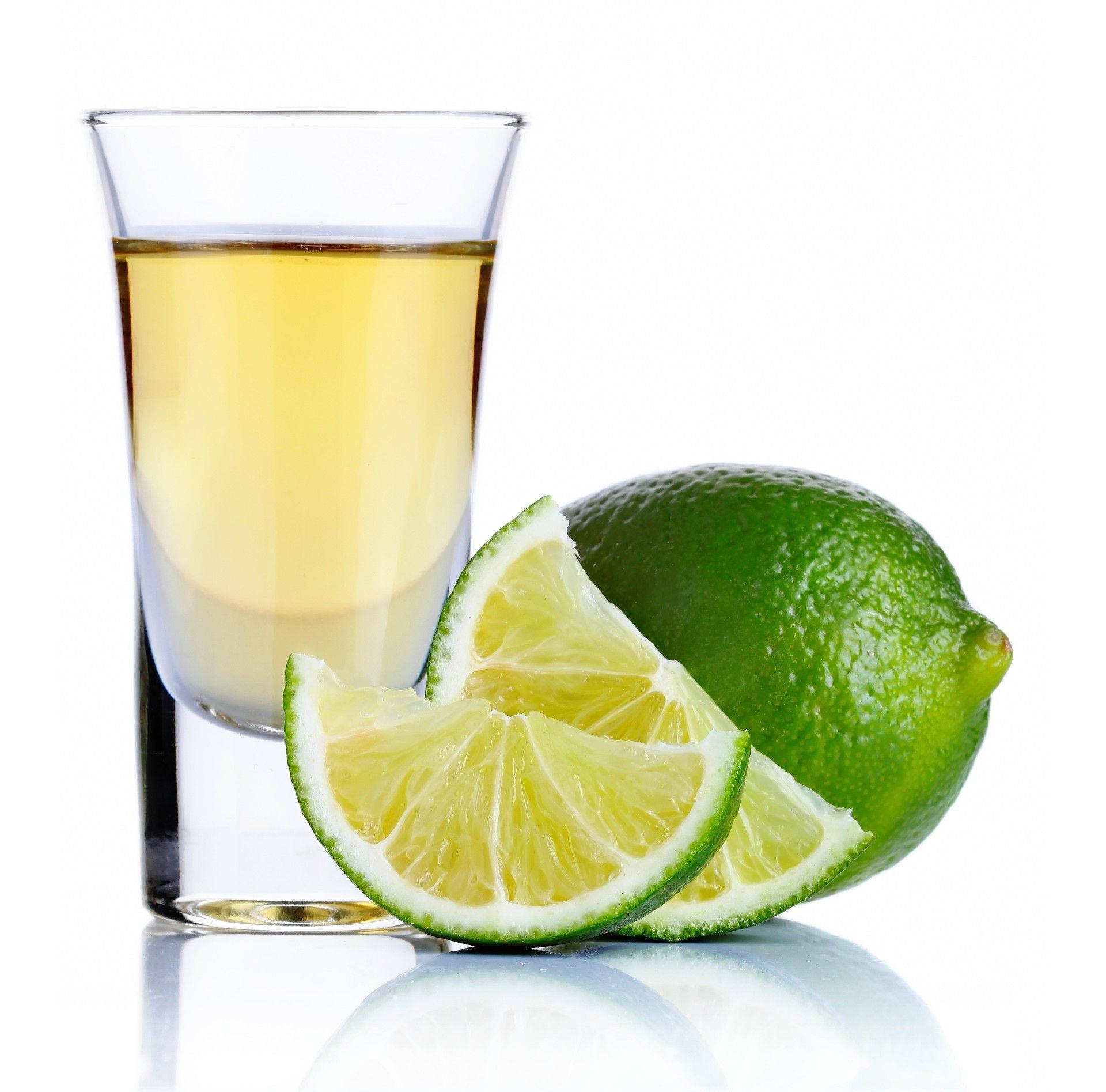 Refreshing Tequila Shots Complemented By Fresh Lime Slices Background