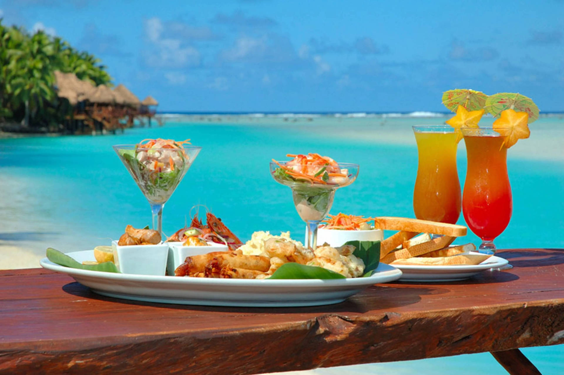 Refreshing Tropical Lunch With Fruity Drinks Background