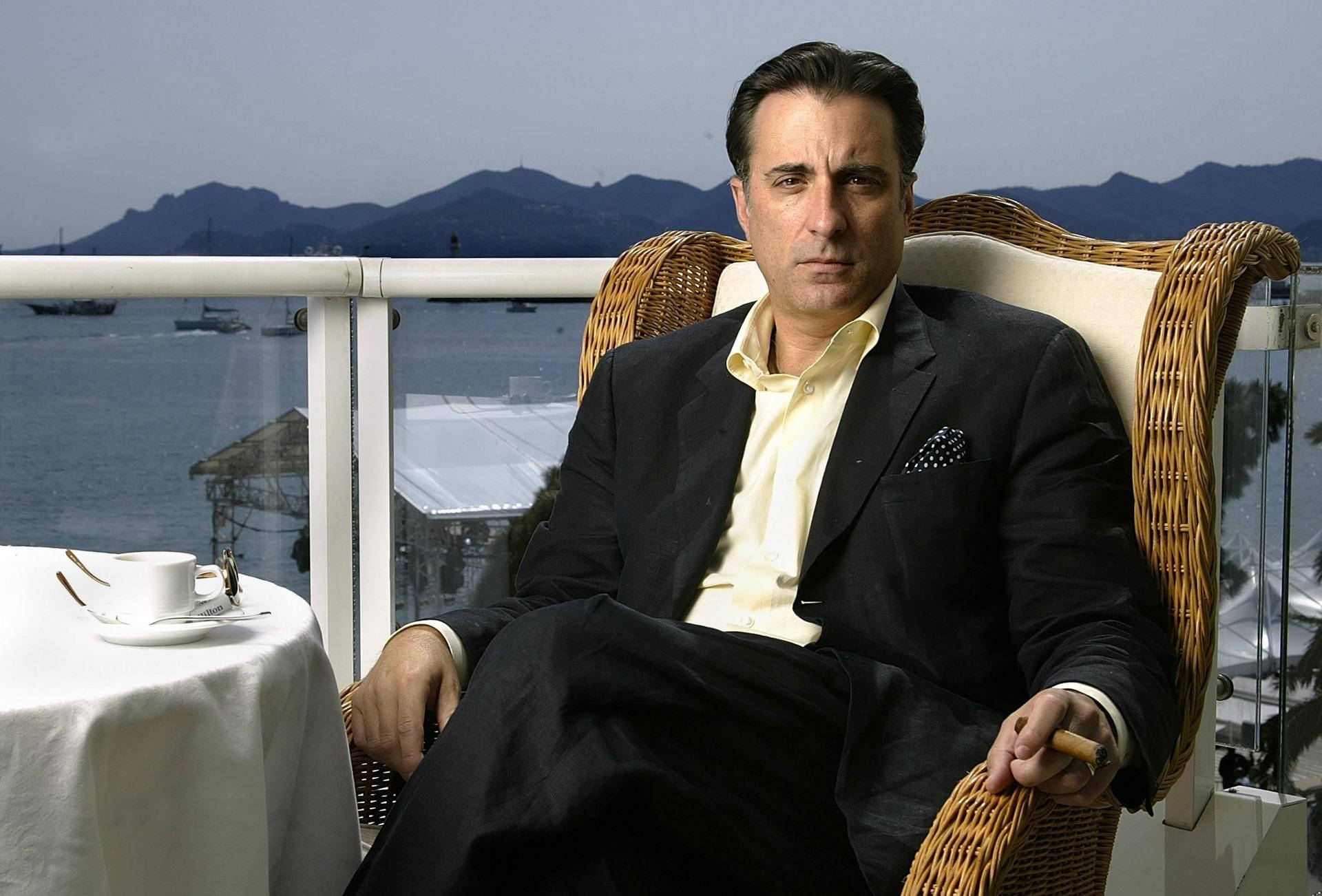 Relaxed Andy Garcia On A Balcony Background