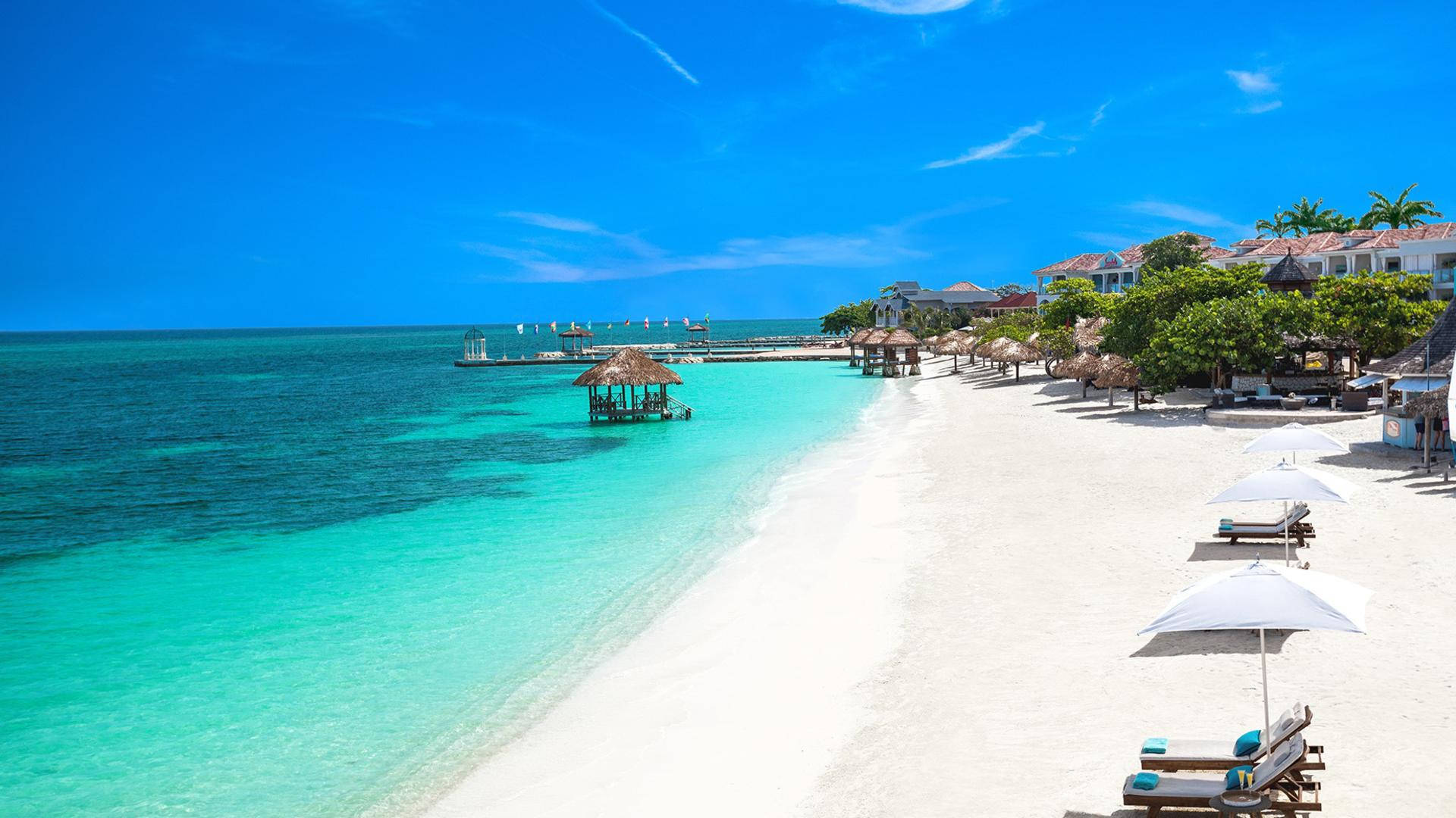 Relaxing Beach Lounge Chairs In Montego Bay Background