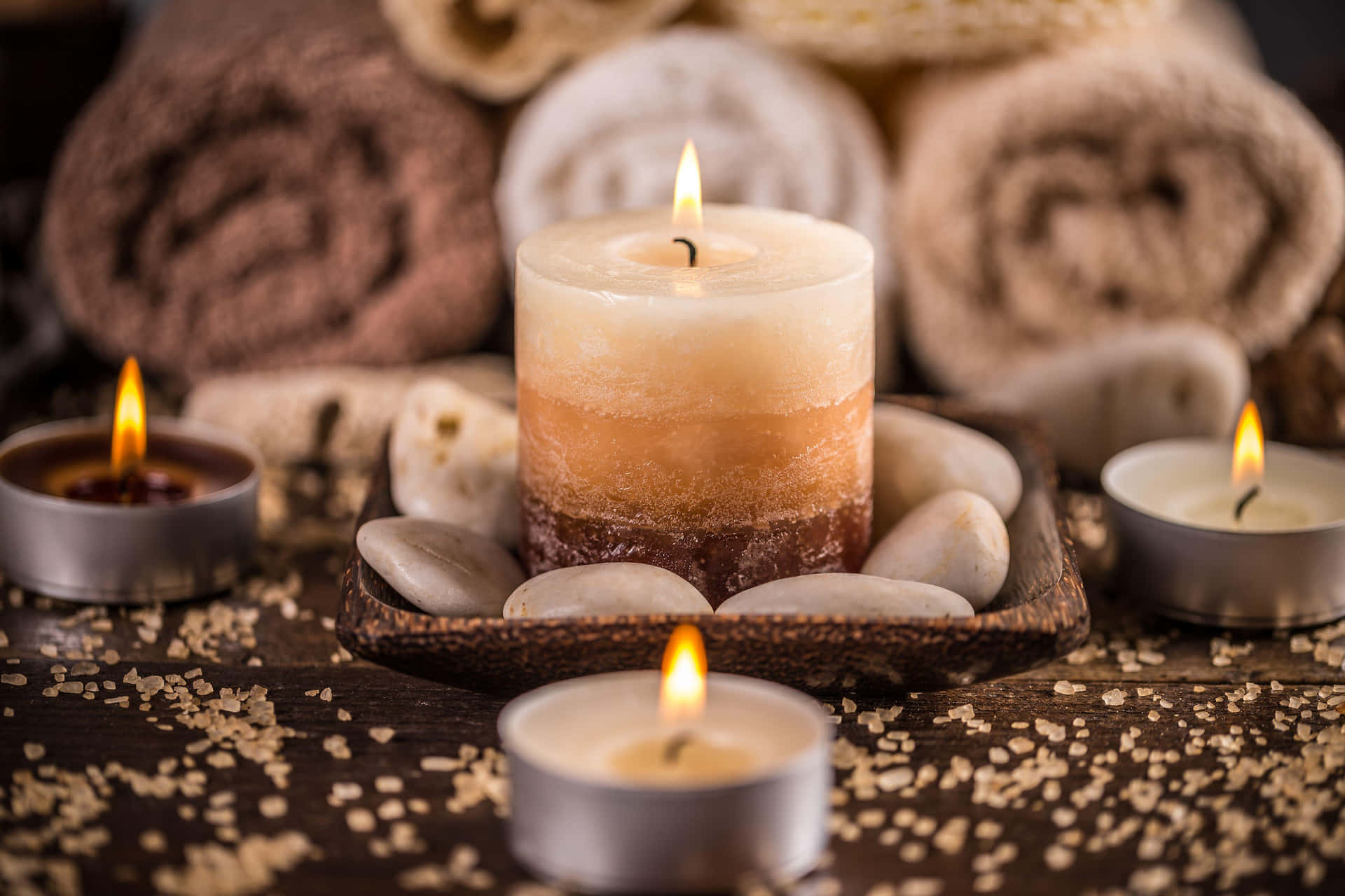 Relaxing Spa Experience Candlesand Towels Background