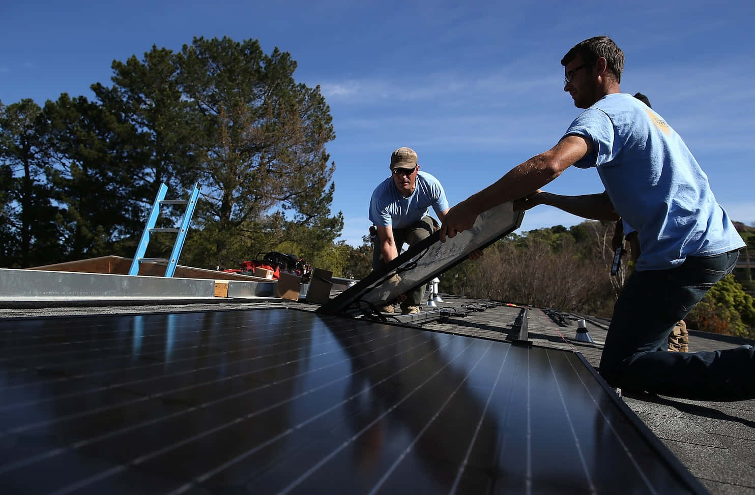 Renewable Energy In Action: Solarcraft Workers Installing Solar Panels Background