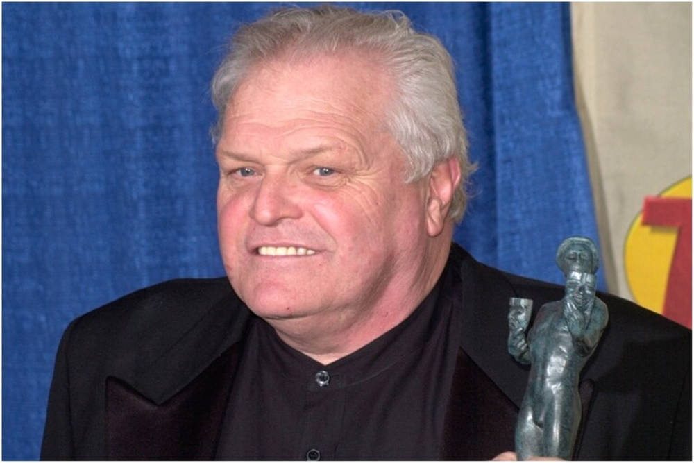 Renowned Actor Brian Dennehy Holding A Trophy Background