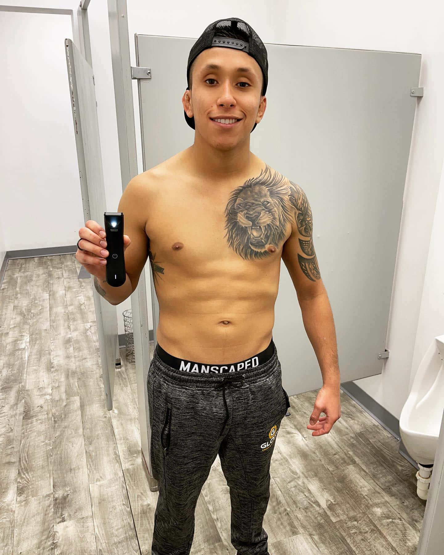 Renowned Fighter Jeff Molina Holding An Electric Shaver Background