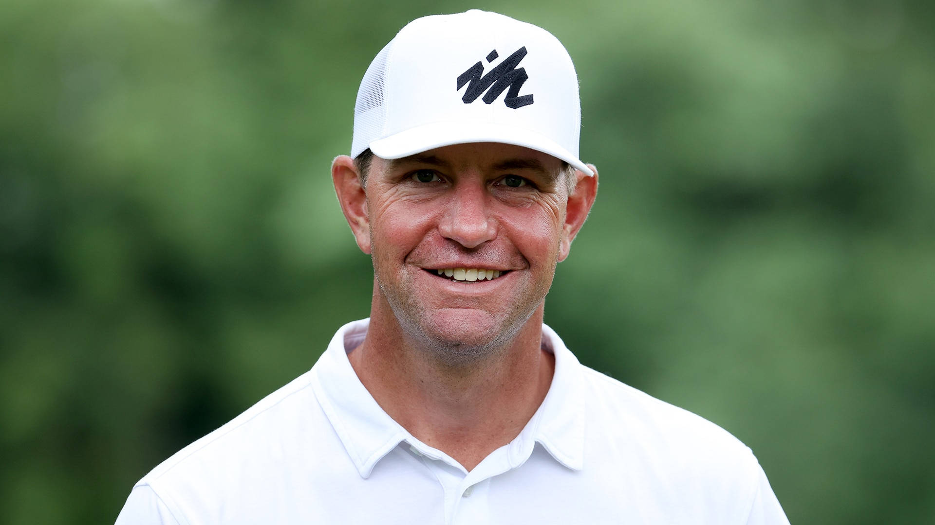 Renowned Golfer Lucas Glover In Striking White Attire Background