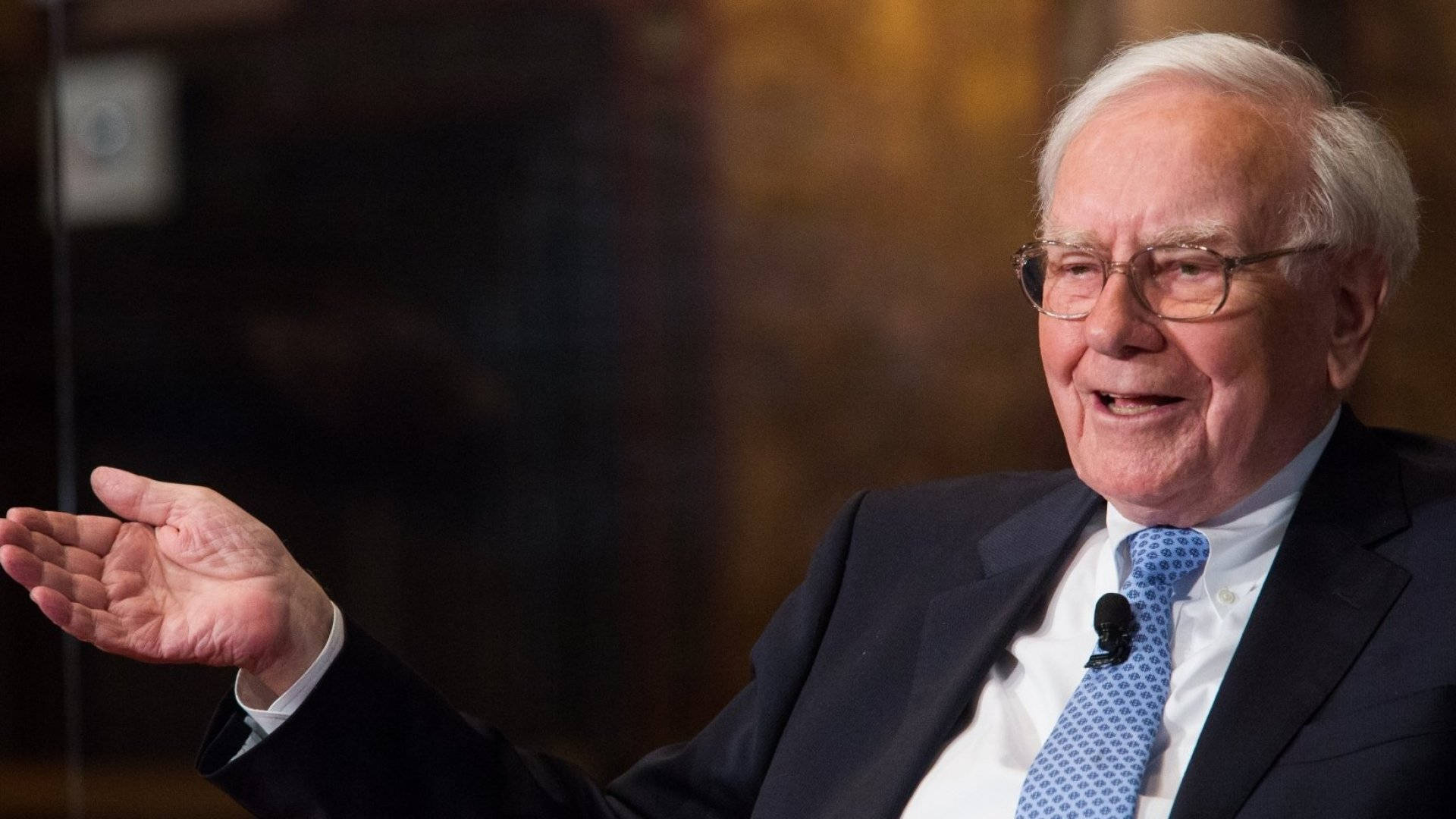 Renowned Investor Warren Buffett Sharing Insights During An Interview Background