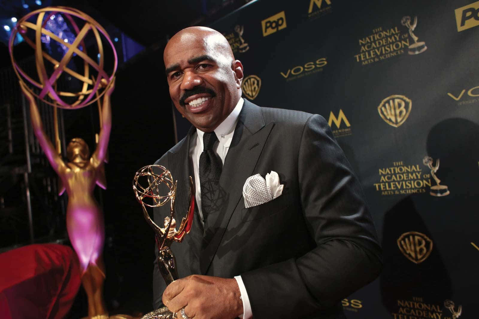 Renowned Tv Personality, Steve Harvey, Proudly Holding His Achievement Award