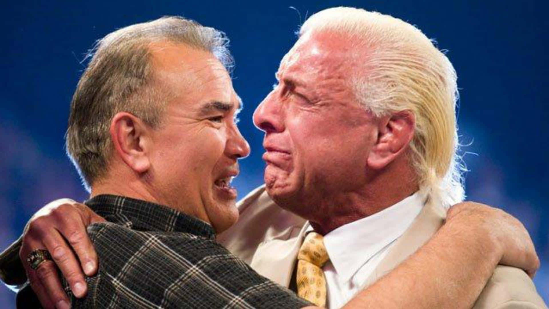 Renowned Wrestlers Ric Flair And Ricky Steamboat Sharing A Moment Background
