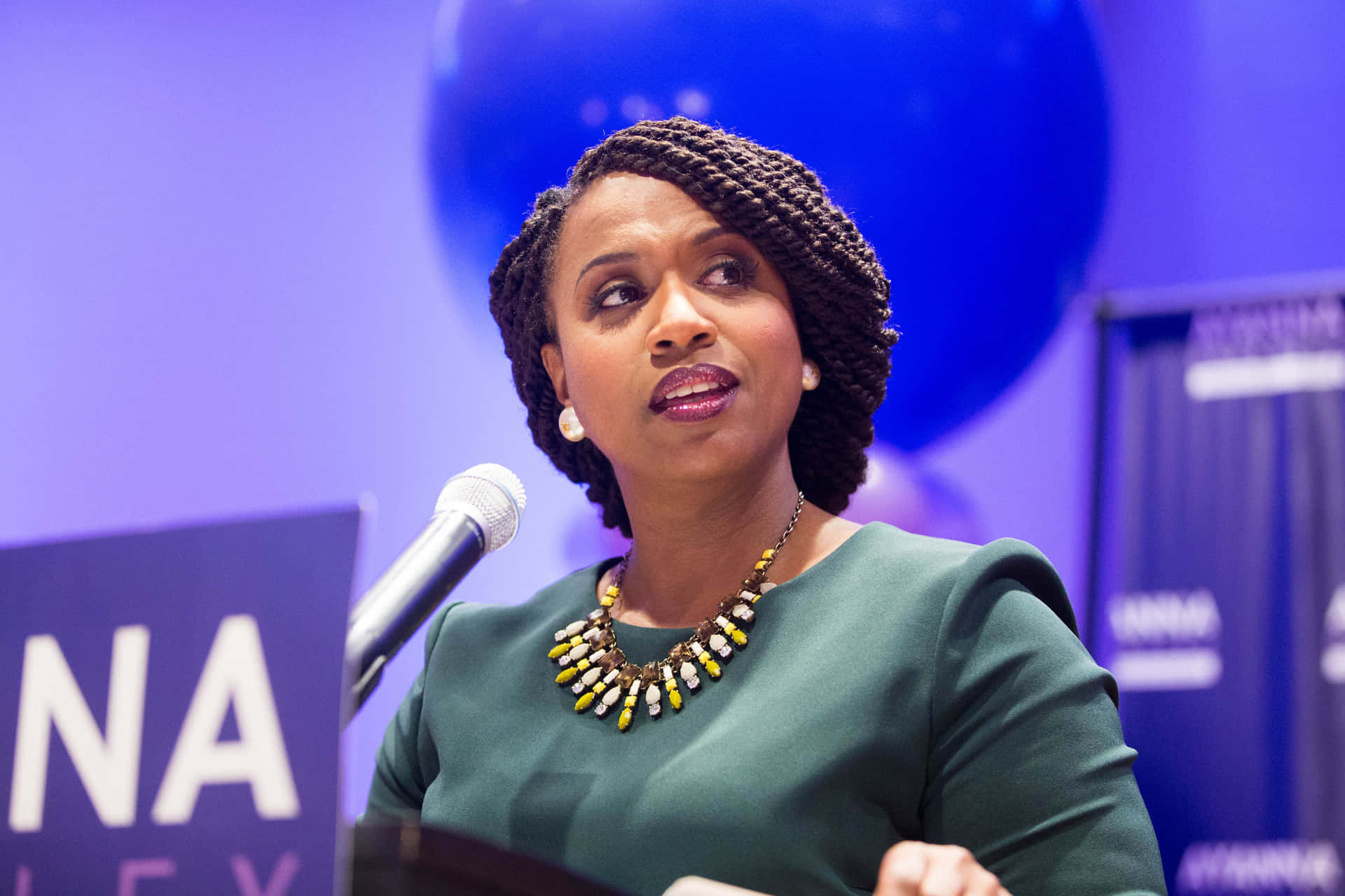 Representative Ayanna Pressley Against A Striking Violet Background Background