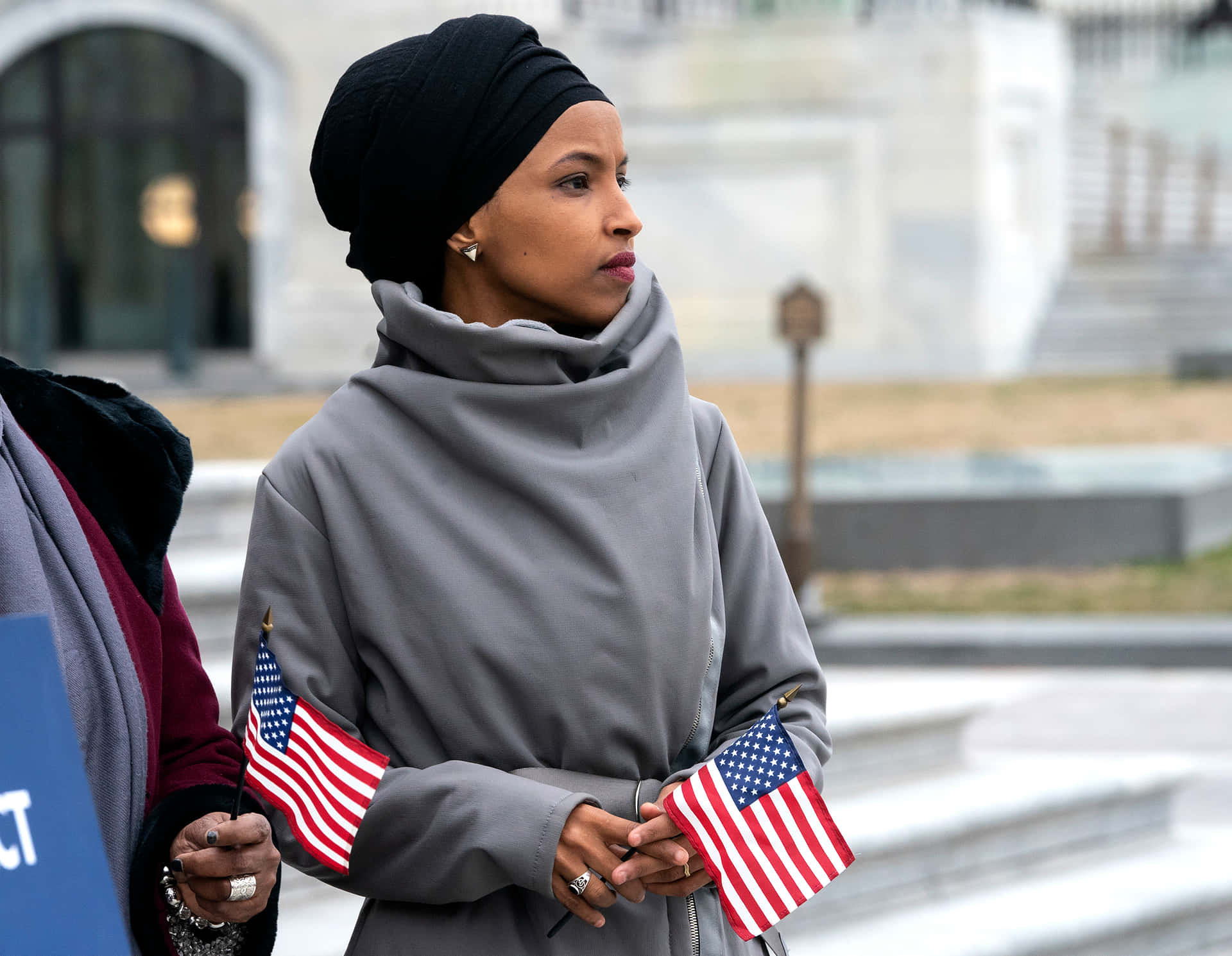 Representative Ilhan Omar Carrying United States Flags Background