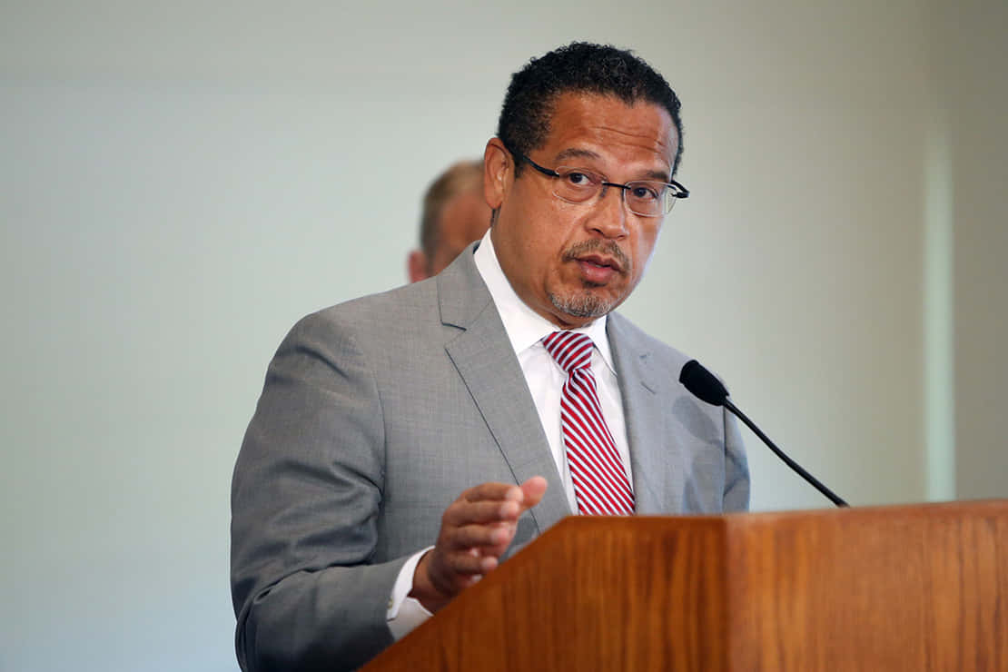 Representative Keith Ellison In A Grey Suit Background
