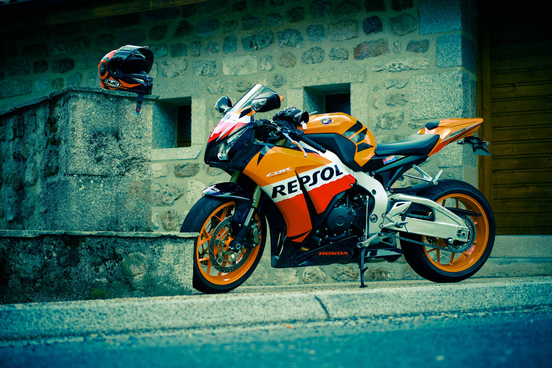 Repsol Honda Motorbike And Helmet Background