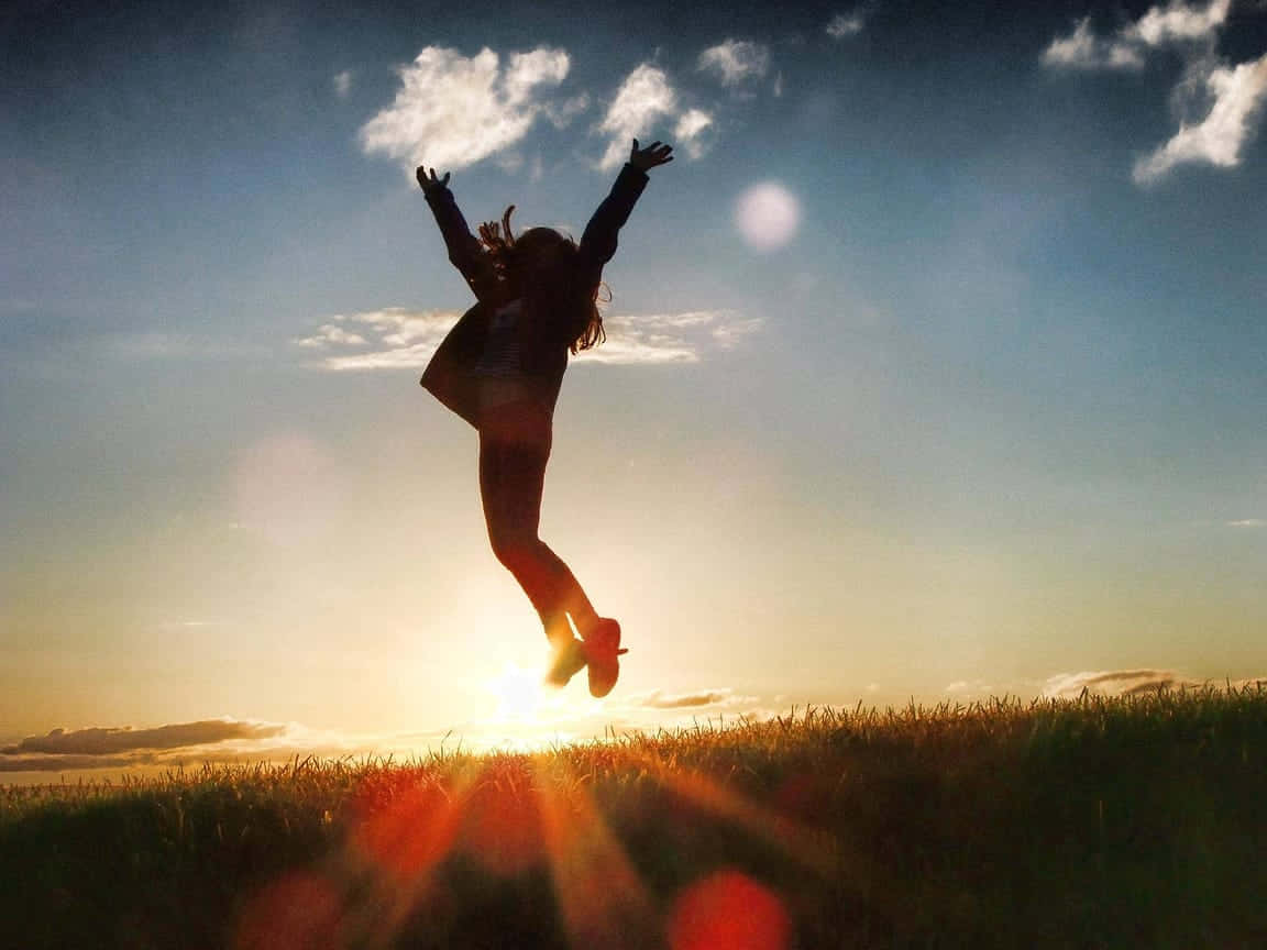 Resilient Person Jumping In Joy Background