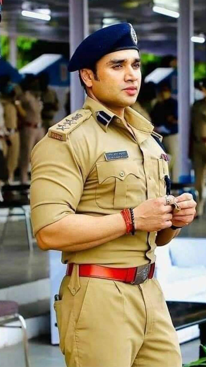 Resolute Indian Police Officer In Uniform Background