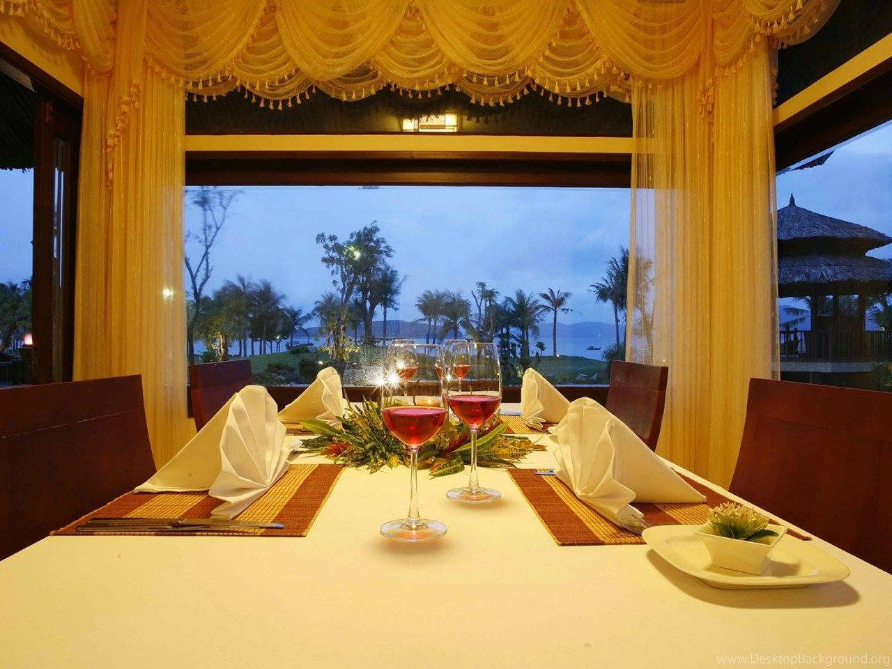 Restaurant Overlooking Coconut Trees And Mountains Background