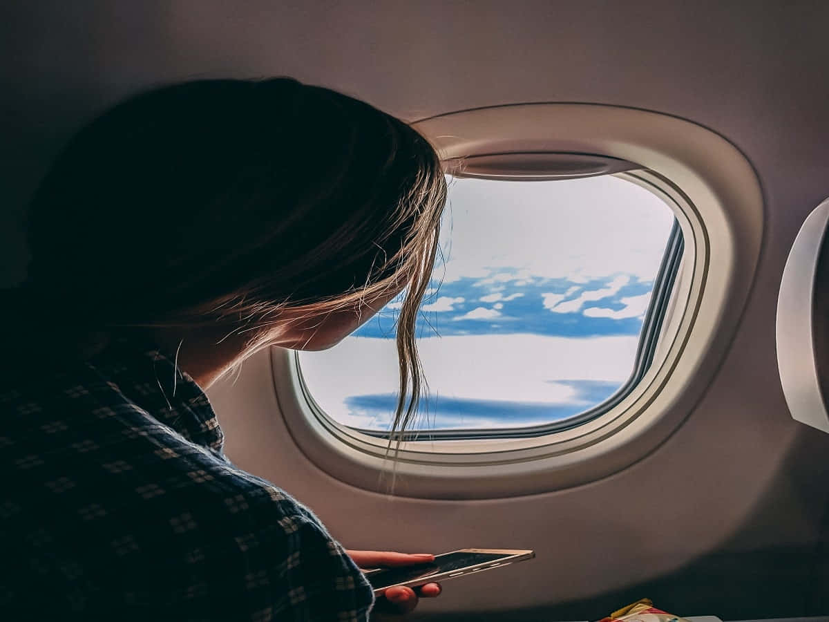 Restless Woman On A Plane Background