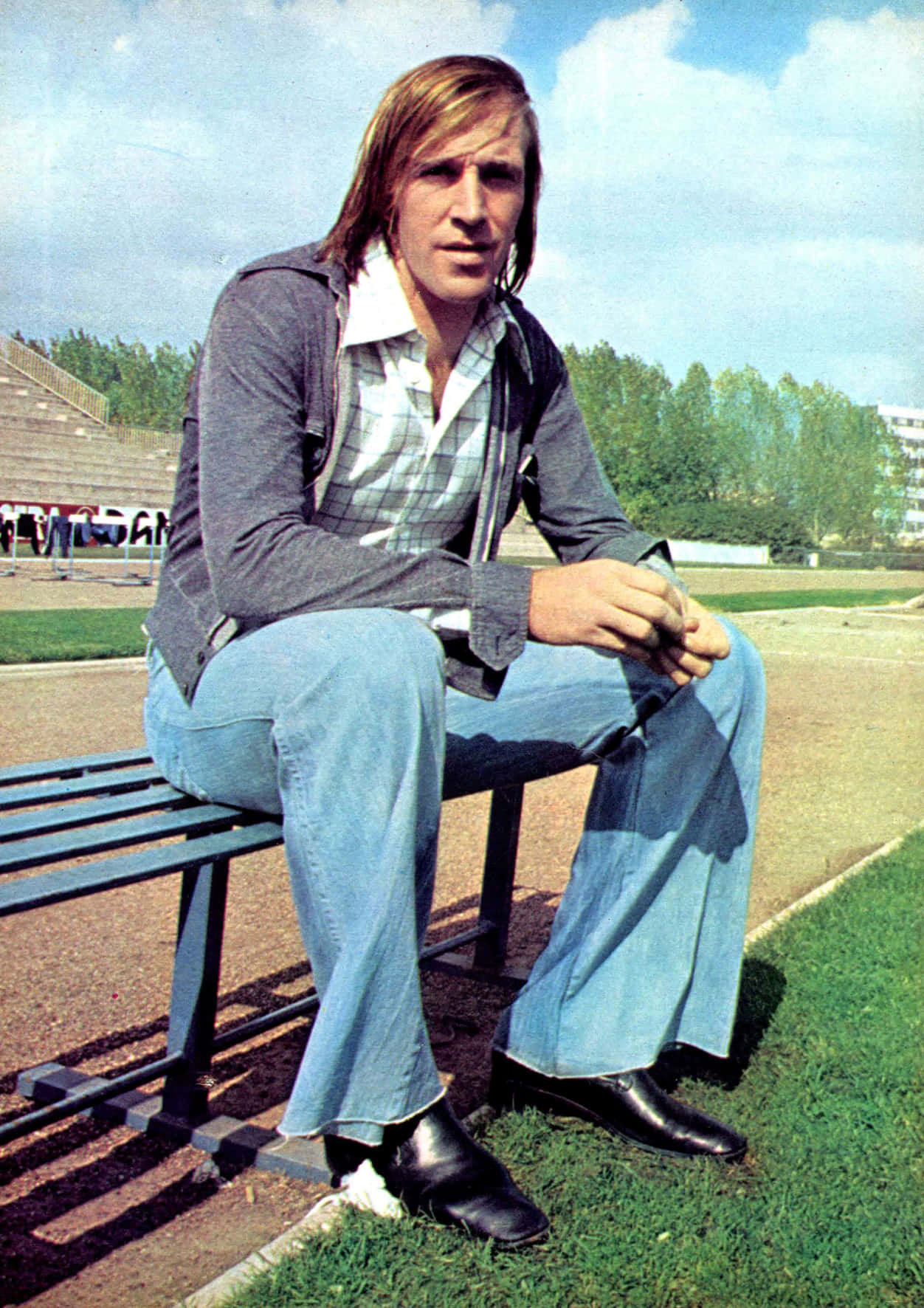 Retro Footballer Sittingon Bench Background
