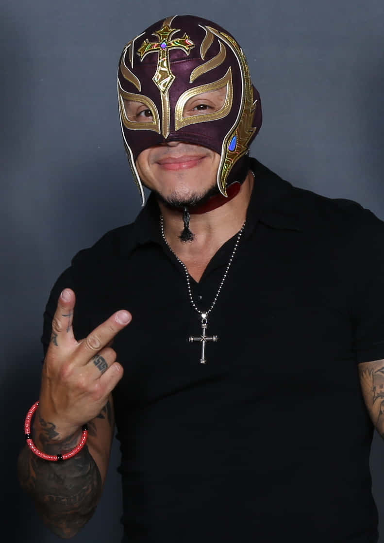 Rey_ Mysterio_ Posing_with_ Peace_ Sign Background