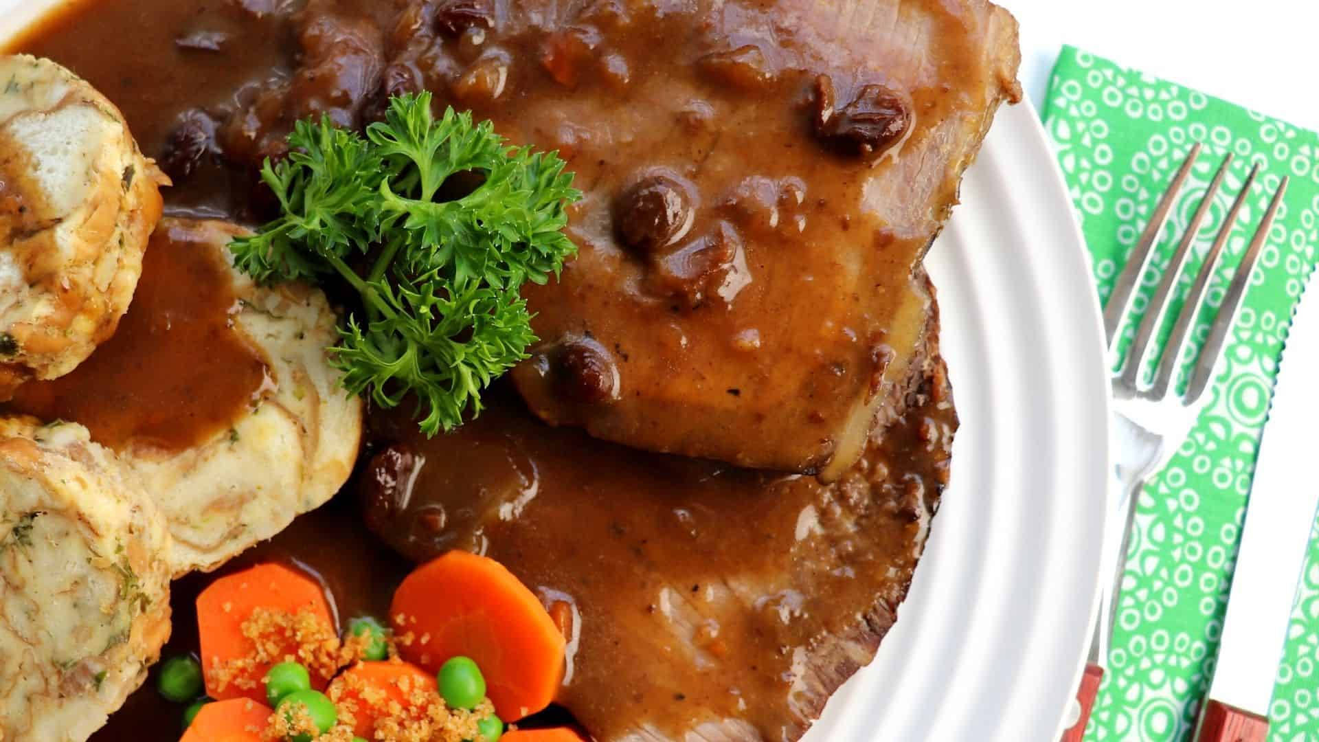 Rhenish Sauerbraten Meal With Carrots And Peas Background