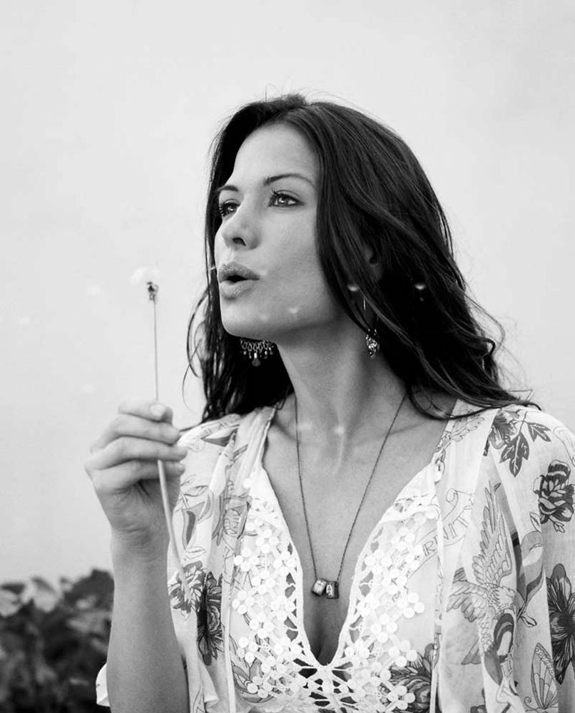 Rhona Mitra Blowing Dandelions Background