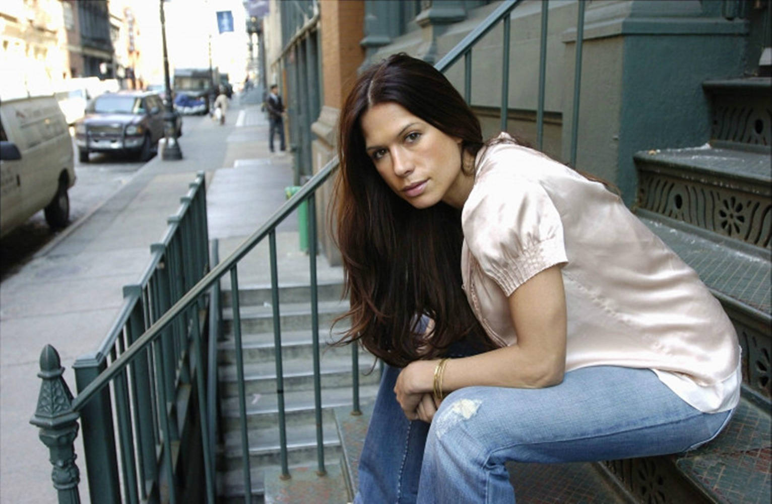 Rhona Mitra Striking A Pose In Stylish Denim Jeans. Background