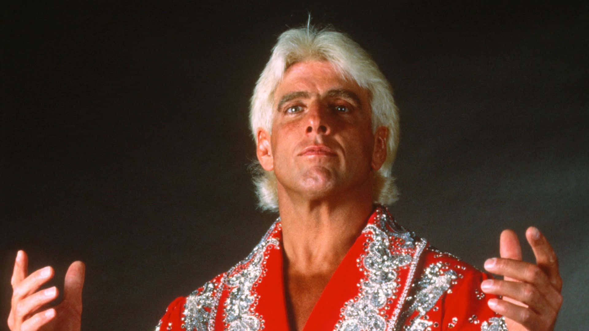 Ric Flair Wearing Red And Silver Robe Background