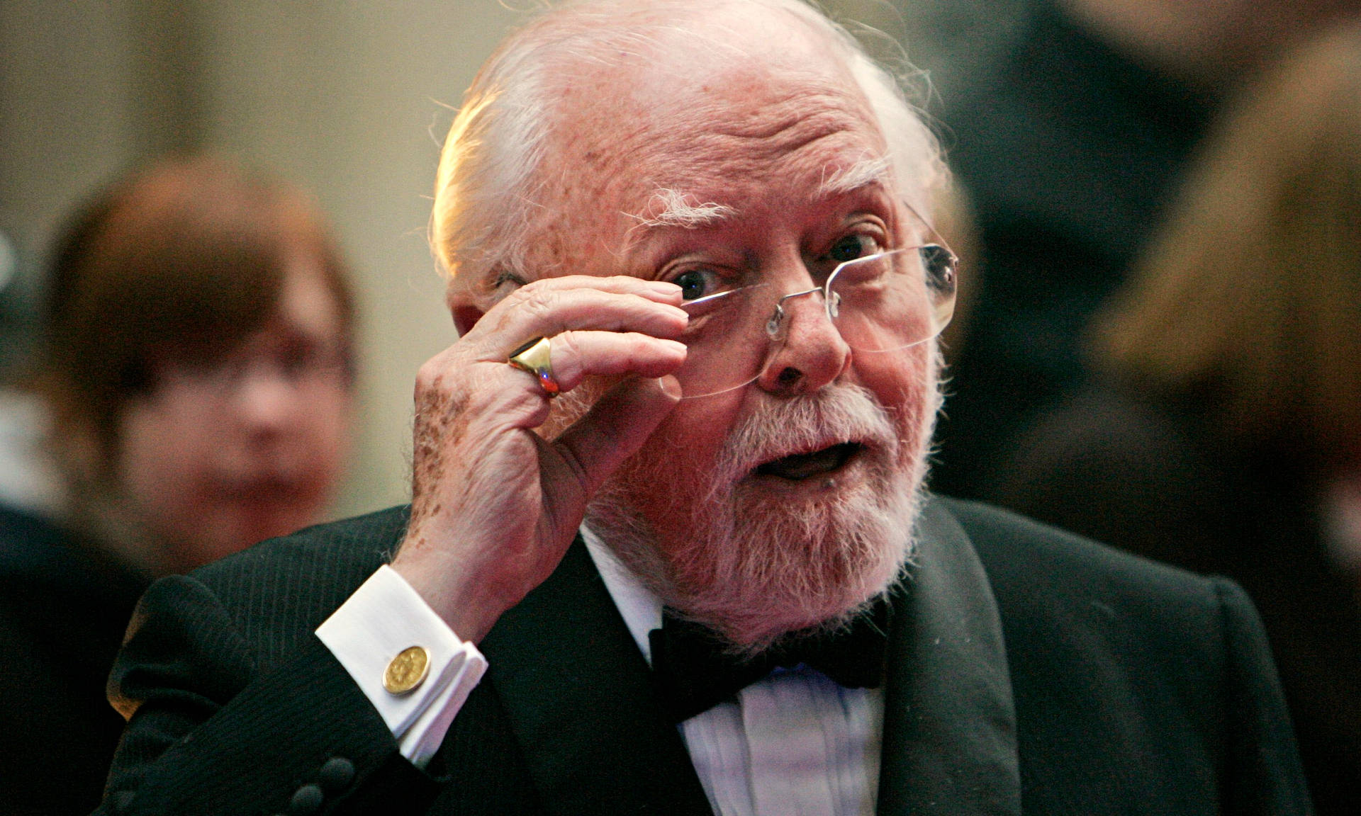 Richard Attenborough Contemplatively Holding His Glasses