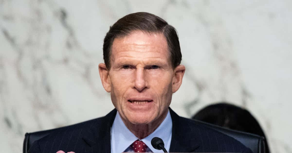 Richard Blumenthal In Front Of A Marble Backdrop Background