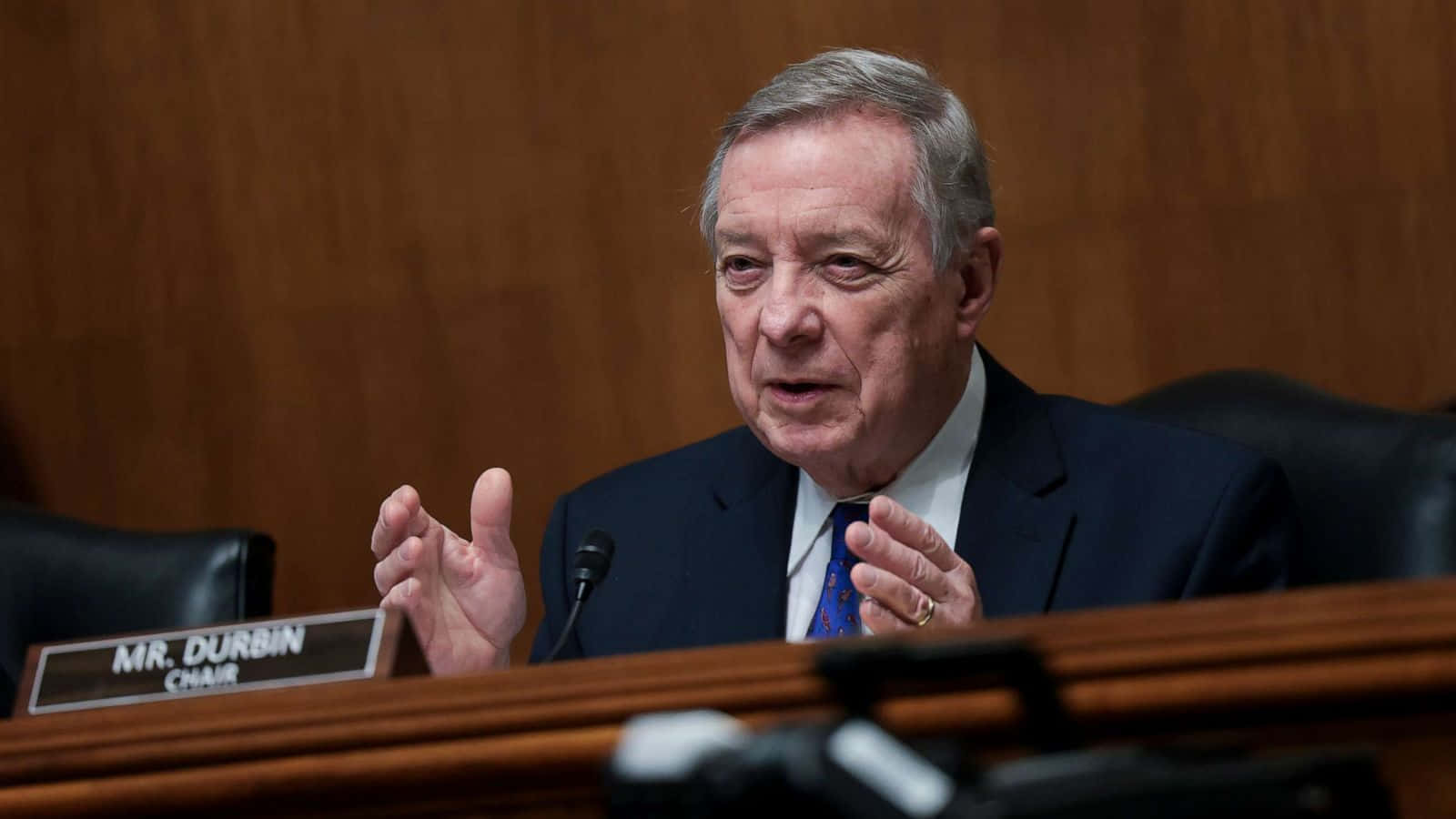 Richard Durbin Talking With Hand Gestures Background
