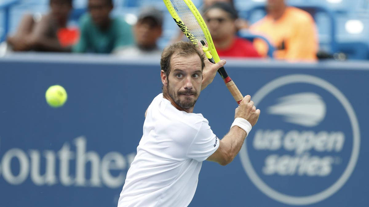 Richard Gasquet In Action, Ready To Hit The Tennis Ball. Background