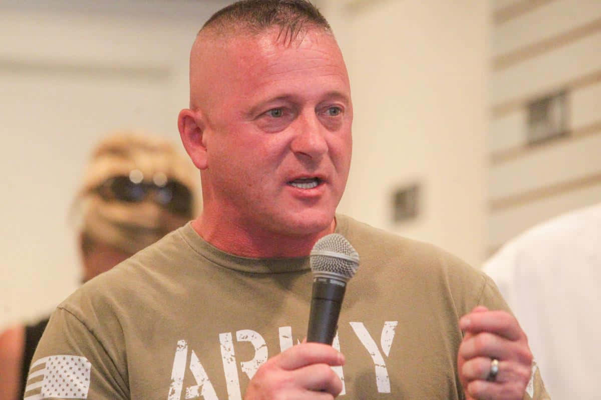 Richard Ojeda Holding A Microphone Background