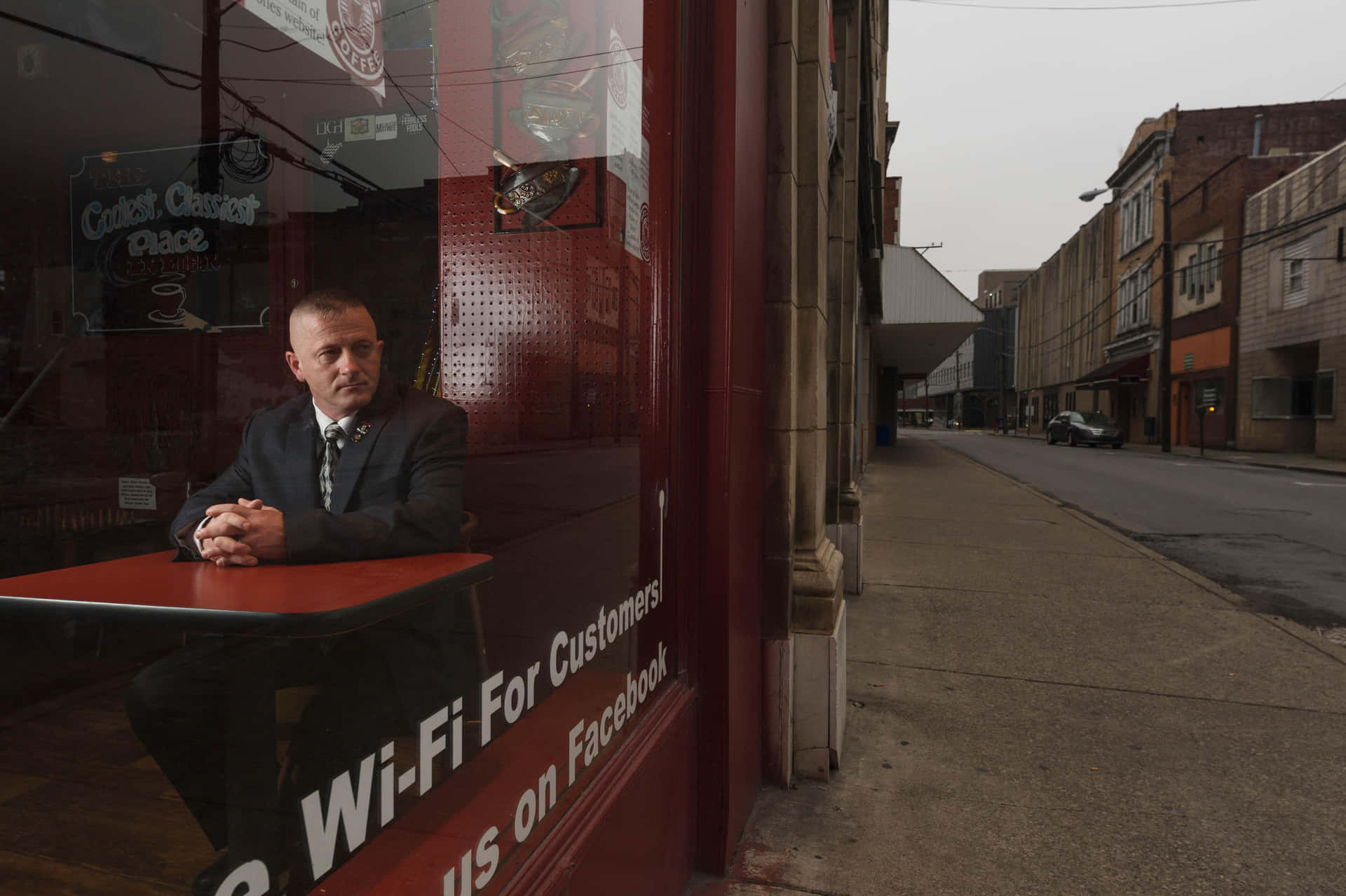 Richard Ojeda Looking Out From Window Background