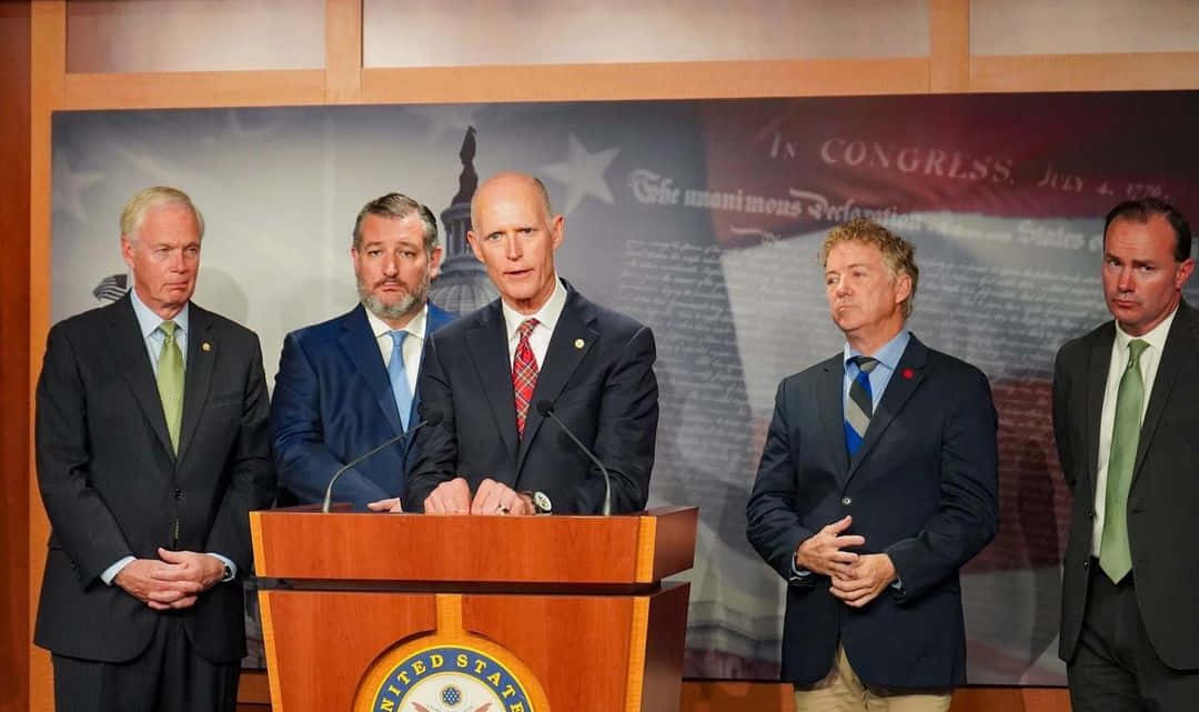 Rick Scott Delivering A Speech Background