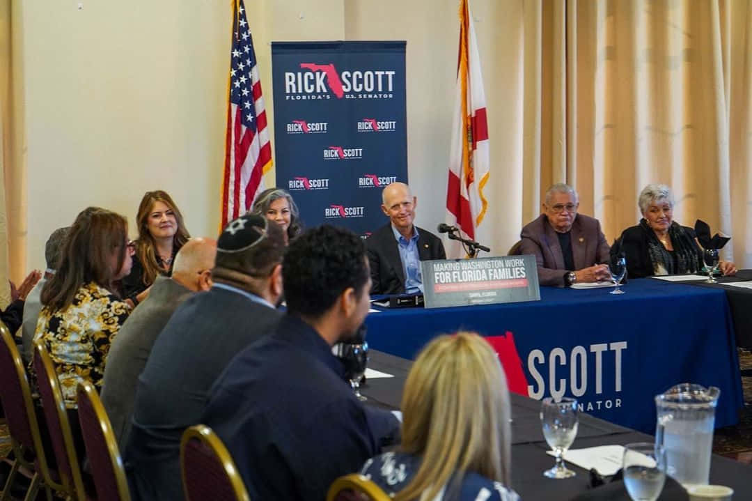 Rick Scott Facilitating Roundtable Discussion Background