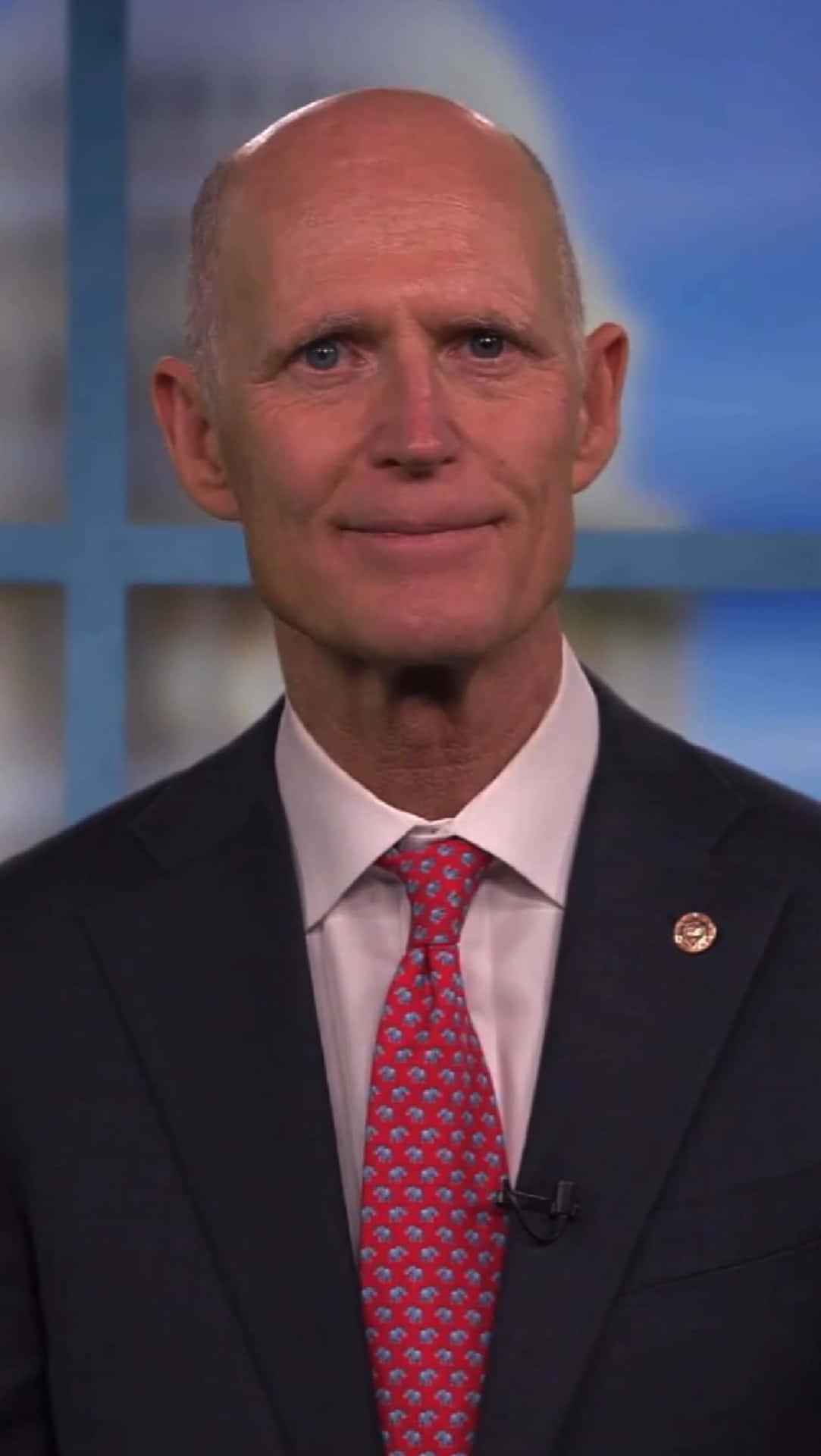 Rick Scott In A Suit Background