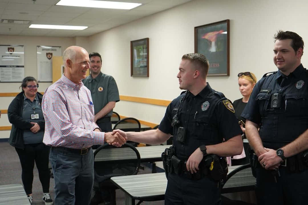 Rick Scott Shaking Hands With Police Officer