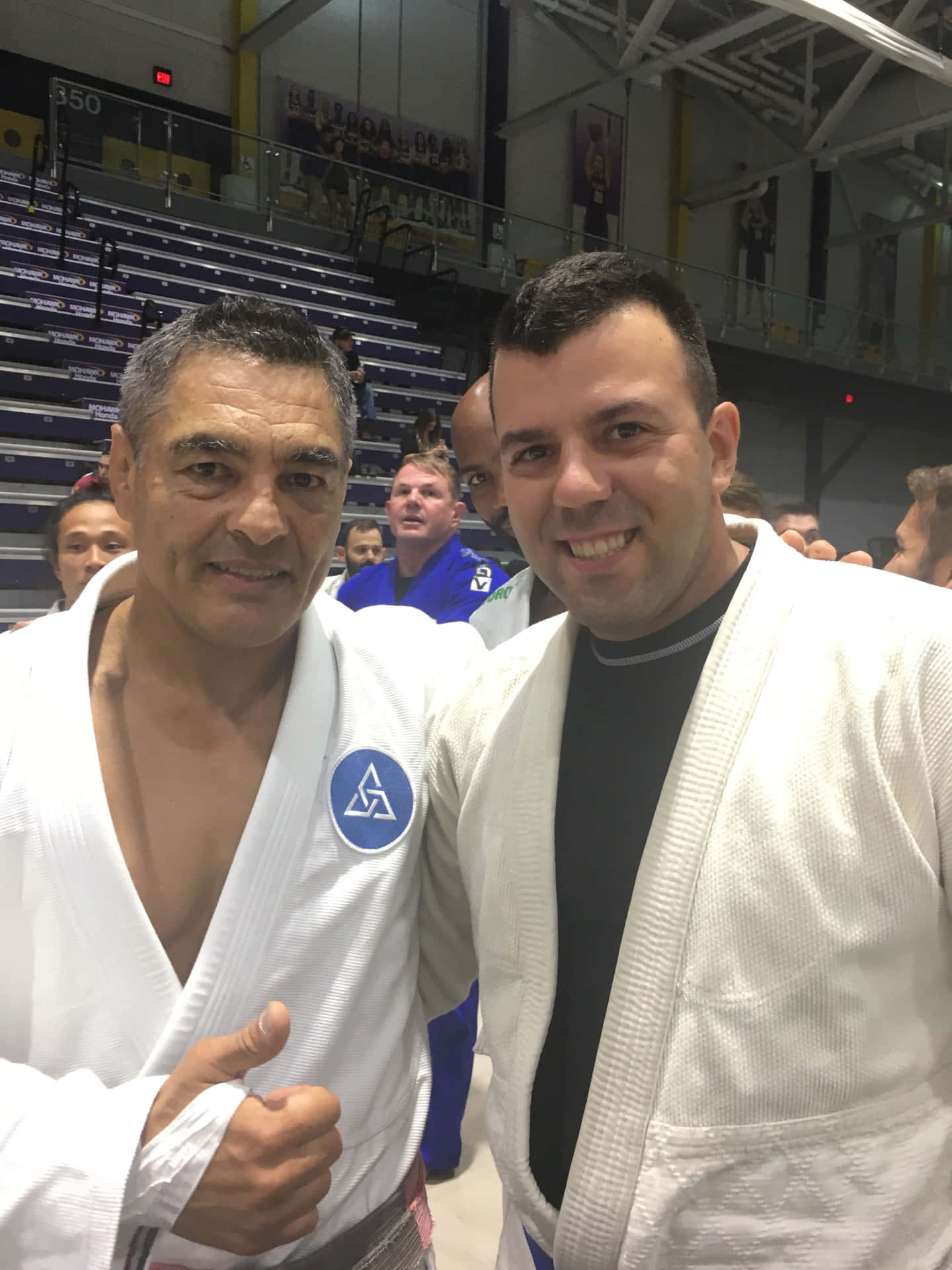 Rickson Gracie With Studentat Gym Background